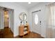 Bright entryway featuring hardwood floors, a decorative mirror, and a stylish storage console at 507 67Th W Ave, Bradenton, FL 34207