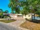 Exterior of home featuring an expansive brick driveway, two-car garage and manicured lawn at 507 67Th W Ave, Bradenton, FL 34207