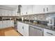 Kitchen area featuring stainless appliances, tile backsplash, and stainless sink at 507 67Th W Ave, Bradenton, FL 34207