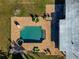 Aerial view of pool and patio area with outside dining and sunbathing furniture at 507 67Th W Ave, Bradenton, FL 34207