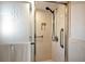 Bright shower featuring glass doors, accessible grab bars, and tile walls at 507 67Th W Ave, Bradenton, FL 34207