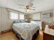 Inviting bedroom featuring paneled walls, a ceiling fan, and a queen bed in a neutral color palette at 511 50Th Avenue W Dr, Bradenton, FL 34207