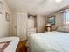 View of the bedroom featuring white paneled walls, closets, a queen bed and light laminate flooring at 511 50Th Avenue W Dr, Bradenton, FL 34207