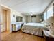 Main bedroom featuring laminate flooring, white paneled walls, closet space, and a cozy setting at 511 50Th Avenue W Dr, Bradenton, FL 34207