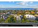 Aerial view of a lovely waterfront home with a boat dock and beautiful view of the bay surrounded by palm trees at 537 Fore Dr, Bradenton, FL 34208