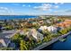 Aerial view of a waterfront neighborhood and a gorgeous waterfront home featuring boat dock and a bay view at 537 Fore Dr, Bradenton, FL 34208