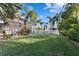 Spacious backyard with lush green grass and tropical palm trees, perfect for outdoor activities at 537 Fore Dr, Bradenton, FL 34208