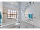 Bathroom featuring shower-tub combo, large vanity, and a decorative window at 537 Fore Dr, Bradenton, FL 34208