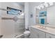 Bathroom featuring walk-in shower with glass door, modern vanity, and decorative tile at 537 Fore Dr, Bradenton, FL 34208