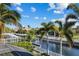 Scenic canal view showcasing tranquil waters, lush landscaping, and waterfront homes under a bright, partly cloudy sky at 537 Fore Dr, Bradenton, FL 34208