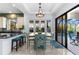 Dining area featuring backyard views, an elegant light fixture, and bar seating at the kitchen counter at 537 Fore Dr, Bradenton, FL 34208