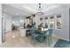 Bright dining area with wood-look tile floors, modern lighting, and ample natural light from the bay window at 537 Fore Dr, Bradenton, FL 34208