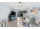 Bright living room with tile floors, white couches, and a sliding glass door to the outdoor patio at 537 Fore Dr, Bradenton, FL 34208