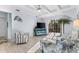 Comfortable living room featuring stylish furniture, a ceiling fan, and sliding doors that lead to outdoor space at 537 Fore Dr, Bradenton, FL 34208