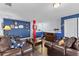 Spacious living room with leather couches, coffee table, nautical decorations and blue accent wall at 537 Fore Dr, Bradenton, FL 34208