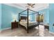 Bedroom featuring a four-poster bed, tile flooring, and sliding glass doors to the outdoors at 537 Fore Dr, Bradenton, FL 34208