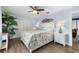 Light-filled bedroom with a ceiling fan, wood-look floors, and a closet for storage at 537 Fore Dr, Bradenton, FL 34208