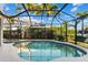 Private screened-in pool and jacuzzi surrounded by lush landscaping and a privacy fence at 537 Fore Dr, Bradenton, FL 34208