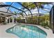 Relaxing screened-in pool with spa, palm trees, and spacious patio area for outdoor living at 537 Fore Dr, Bradenton, FL 34208