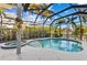 Inviting screened-in pool area with a luxurious pool, relaxing spa, and a private outdoor setting at 537 Fore Dr, Bradenton, FL 34208