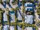 Aerial view of a cozy home with a private pool surrounded by lush greenery and neighboring houses at 5807 De Palmas Ave, Holmes Beach, FL 34217