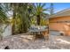 Landscaped backyard featuring a dining area with brick pavers and lush foliage at 5807 De Palmas Ave, Holmes Beach, FL 34217