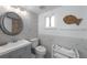 Elegant bathroom with modern fixtures, decorative fish art and tiled walls at 5807 De Palmas Ave, Holmes Beach, FL 34217