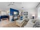 Comfortable living room with white sofas, TV, and bright natural light, seamlessly connected to the kitchen at 5807 De Palmas Ave, Holmes Beach, FL 34217