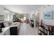 Cozy living room with white tile floors and daybed that leads to the patio at 5807 De Palmas Ave, Holmes Beach, FL 34217