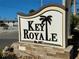 Key Royale community sign featuring a palm tree and stone base at 607 Baronet Ln, Holmes Beach, FL 34217