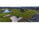 Aerial shot of the golf course, highlighting sand traps, a water hazard and proximity to the waterfront residential community at 607 Baronet Ln, Holmes Beach, FL 34217