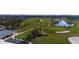 Scenic aerial view of the golf course featuring lush greens, sand traps, a water hazard and meticulously maintained fairways at 607 Baronet Ln, Holmes Beach, FL 34217