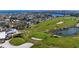 Aerial view of the golf course, showcasing the waterfront community, challenging layout, and beautiful landscaping at 607 Baronet Ln, Holmes Beach, FL 34217