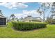 Well-maintained backyard featuring lush green grass and a neatly trimmed hedge creating privacy at 6330 Green Oak Cir # D, Bradenton, FL 34203