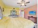 Bedroom featuring neutral walls, a ceiling fan, and a TV for relaxing entertainment at 6330 Green Oak Cir # D, Bradenton, FL 34203