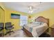 Bright bedroom with modern ceiling fan, tv, and accent chair at 6330 Green Oak Cir # D, Bradenton, FL 34203