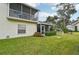 Exterior view of a home featuring a balcony, screened-in porch, and green lawn at 6330 Green Oak Cir # D, Bradenton, FL 34203