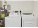 Laundry room area with washer, dryer, and water heater at 6330 Green Oak Cir # D, Bradenton, FL 34203