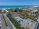 Aerial view of the beach with tennis courts and a pool at 6415 Midnight Pass Rd # 508, Sarasota, FL 34242