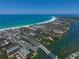 Stunning aerial view of the community, highlighting its beachfront location, amenities, and marina at 6415 Midnight Pass Rd # 508, Sarasota, FL 34242