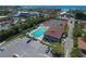 Aerial view of a pool and tennis courts near the waterfront at 6415 Midnight Pass Rd # 508, Sarasota, FL 34242