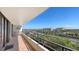 Condo balcony shows tiled flooring and railings, with a view of a highway, marina, and waterfront at 6415 Midnight Pass Rd # 508, Sarasota, FL 34242