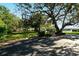 Community basketball court near large shade trees in a grassy park-like setting at 6415 Midnight Pass Rd # 508, Sarasota, FL 34242