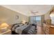 Bedroom with two beds featuring neutral-toned walls, carpet, ceiling fan, and a sliding glass door to a balcony at 6415 Midnight Pass Rd # 508, Sarasota, FL 34242