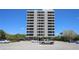 High-rise condo showcasing multiple balconies, set against a clear blue sky at 6415 Midnight Pass Rd # 508, Sarasota, FL 34242