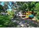 Community canoe and kayak storage racks near a small shed, surrounded by lush greenery at 6415 Midnight Pass Rd # 508, Sarasota, FL 34242