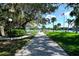 Scenic community park featuring walking path, bay views, mature shade trees, and an American flag at 6415 Midnight Pass Rd # 508, Sarasota, FL 34242