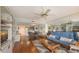 Cozy living room area featuring hardwood floors, comfortable furniture, and a mirrored accent wall at 6415 Midnight Pass Rd # 508, Sarasota, FL 34242