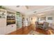 View from living room, showing dining area and kitchen, with hardwood floors and neutral tones at 6415 Midnight Pass Rd # 508, Sarasota, FL 34242