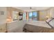 Bedroom featuring neutral wall colors, carpet, a dresser, and a sliding glass door to a private balcony at 6415 Midnight Pass Rd # 508, Sarasota, FL 34242